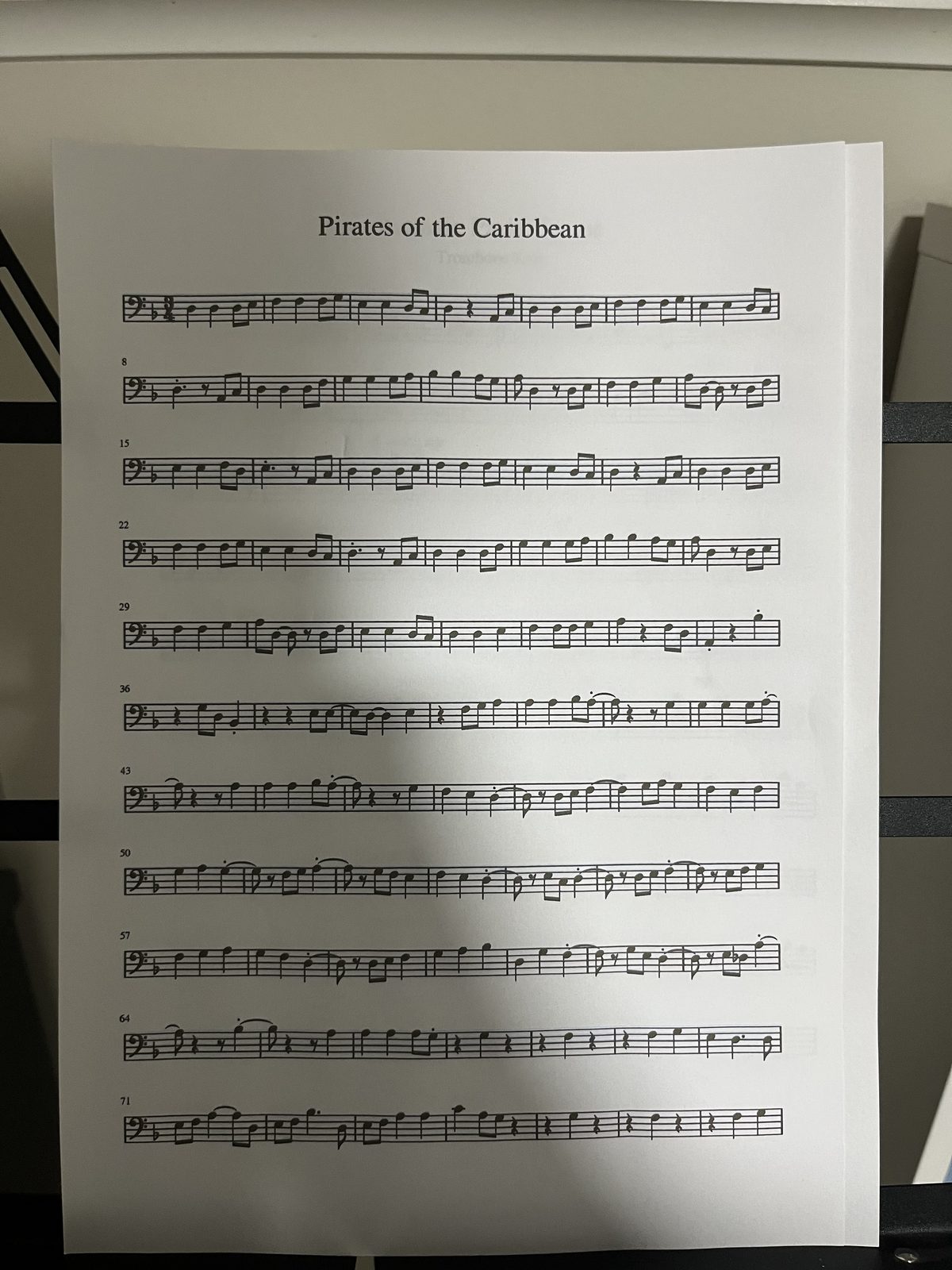 Pirates of the Caribbean, a loose trombone part photographed on a table with a shadow across it